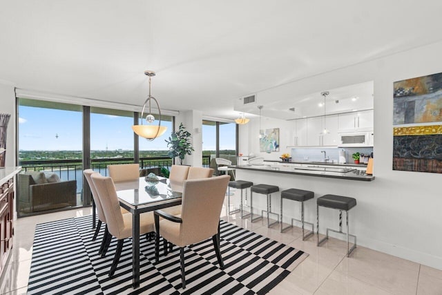 dining area featuring sink and expansive windows