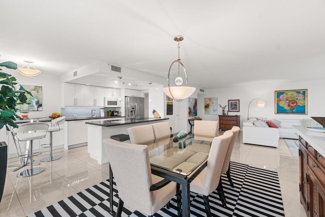 tiled dining area featuring sink