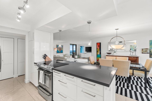 kitchen with white cabinetry, decorative light fixtures, light tile patterned floors, track lighting, and stainless steel electric stove