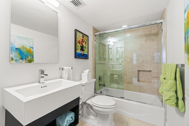 full bathroom featuring vanity, tile patterned floors, toilet, and combined bath / shower with glass door