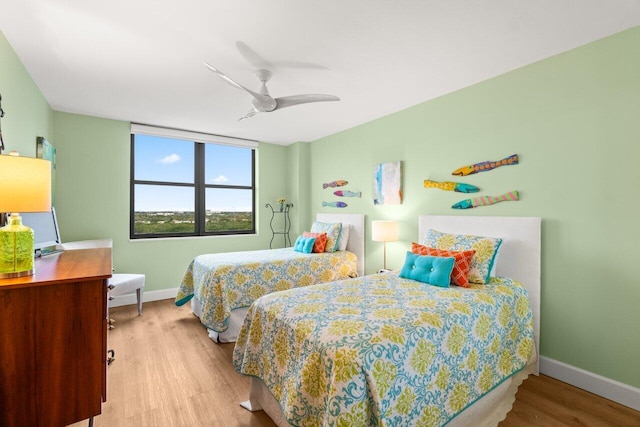 bedroom with hardwood / wood-style flooring and ceiling fan