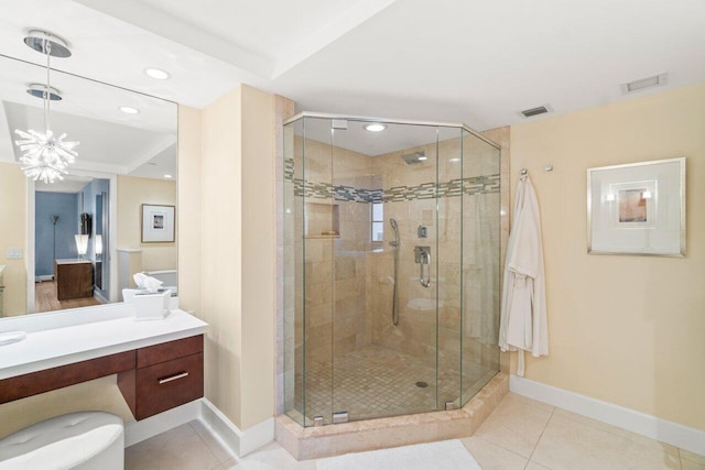 bathroom featuring walk in shower, tile patterned floors, vanity, and a notable chandelier