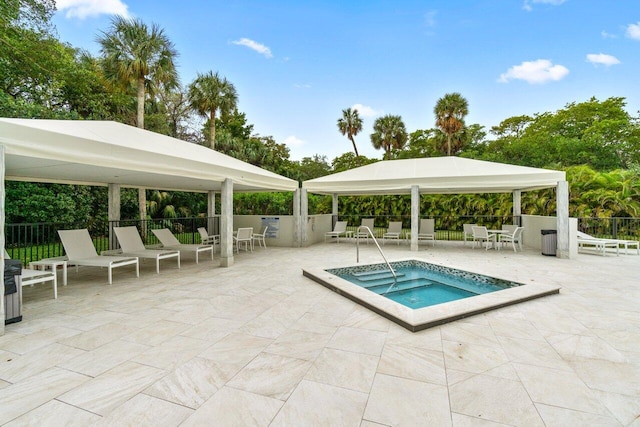 view of pool with a hot tub, a gazebo, and a patio