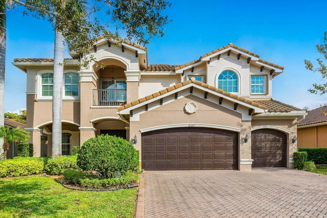 8187 Mariano Falls Ln, Boynton Beach, FL 33473 - mediterranean / spanish home with a tile roof, stucco siding, decorative driveway, and a balcony