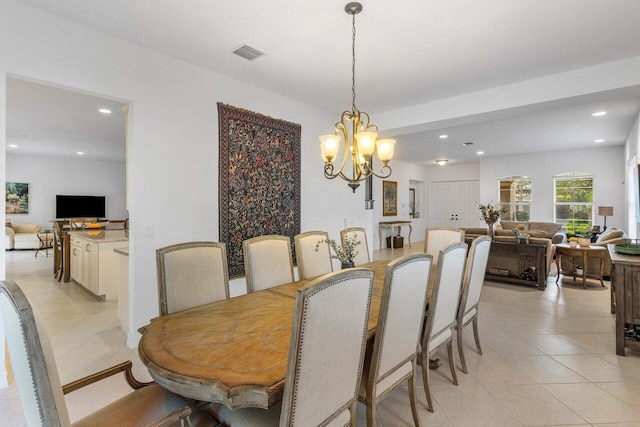 dining area featuring an inviting chandelier and light tile patterned floors