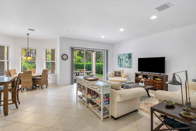 living room with light tile patterned floors and a textured ceiling