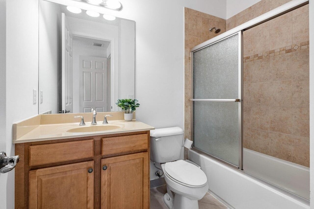 full bathroom with vanity, toilet, and combined bath / shower with glass door