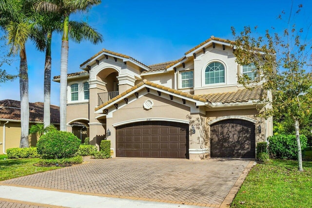8187 Mariano Falls Ln, Boynton Beach, FL 33473 - mediterranean / spanish home featuring a balcony, stucco siding, decorative driveway, an attached garage, and a tile roof