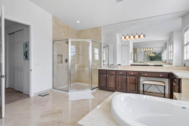 bathroom featuring shower with separate bathtub and vanity