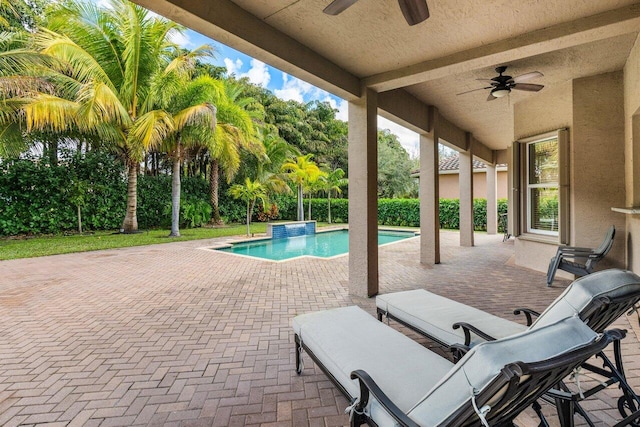 view of swimming pool with a patio and ceiling fan