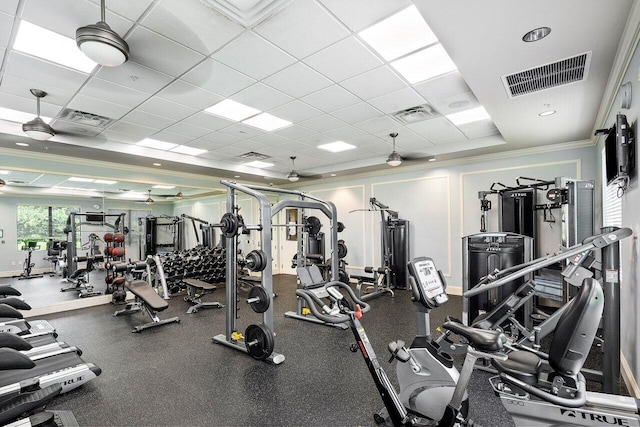 exercise room featuring a drop ceiling and crown molding