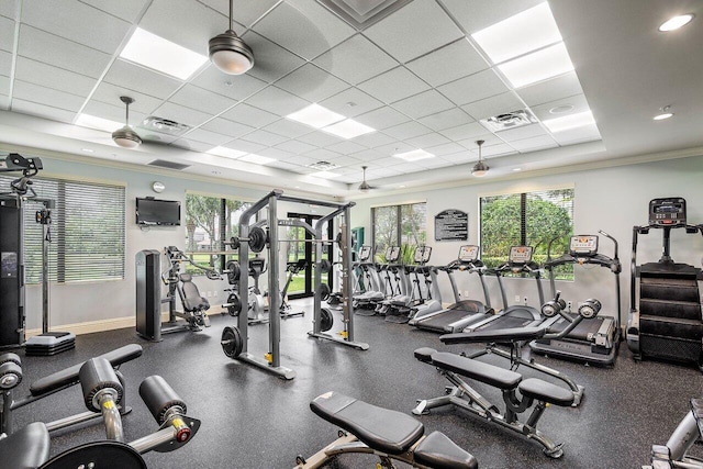 exercise room featuring a drop ceiling and ornamental molding