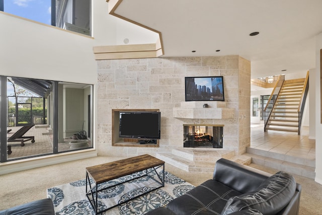 carpeted living room with a multi sided fireplace