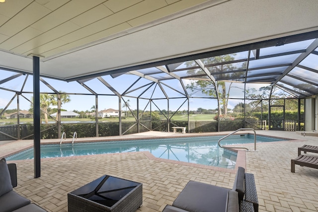 view of pool with a patio and glass enclosure