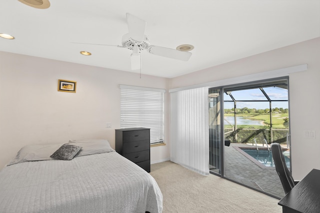 carpeted bedroom with a water view, access to outside, and ceiling fan