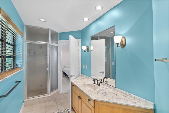 bathroom featuring vanity, an enclosed shower, and tile patterned floors