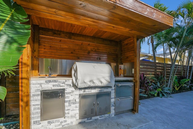 view of patio / terrace with exterior kitchen, sink, and grilling area