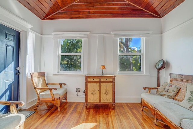 sitting room featuring vaulted ceiling, wooden ceiling, light wood-type flooring, and a wealth of natural light