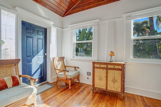 sitting room with lofted ceiling, wood ceiling, and light wood-type flooring