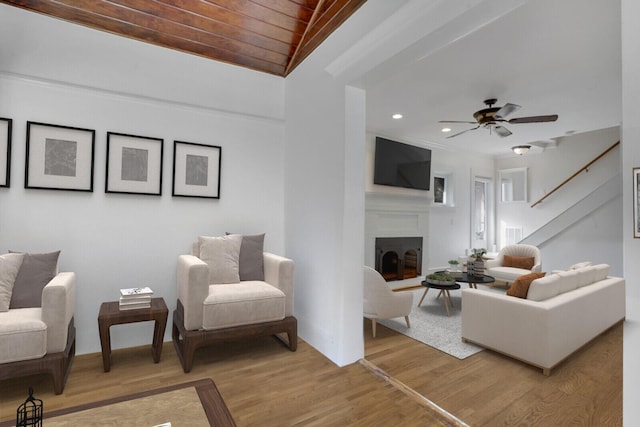 living room featuring wood-type flooring, lofted ceiling, ceiling fan, and wood ceiling