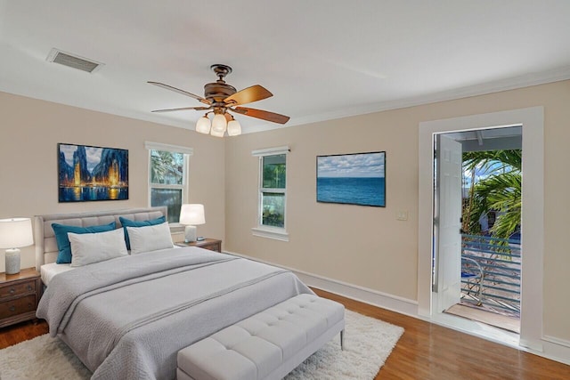 bedroom with hardwood / wood-style flooring, ornamental molding, access to outside, and ceiling fan