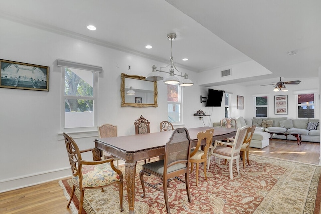 dining room with crown molding, ceiling fan, and light wood-type flooring