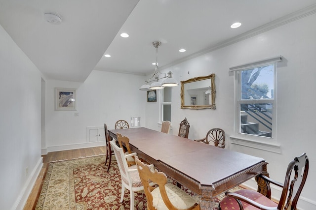 dining area featuring hardwood / wood-style flooring and crown molding