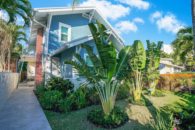 view of side of home with a lawn