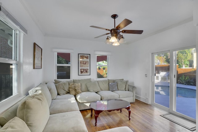 living room with light hardwood / wood-style flooring and ceiling fan