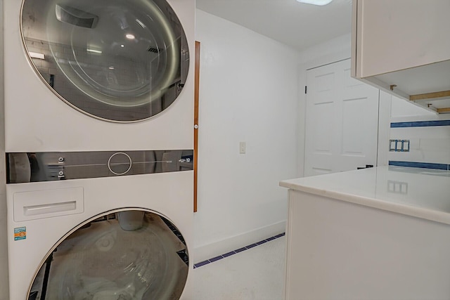 washroom featuring stacked washer and dryer