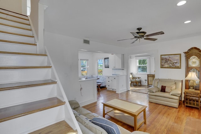 living room with ceiling fan and light hardwood / wood-style floors