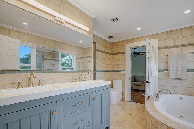 full bathroom with toilet, separate shower and tub, tile walls, ornamental molding, and vanity