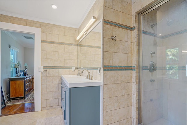 bathroom featuring tile walls, tile patterned flooring, ornamental molding, and walk in shower