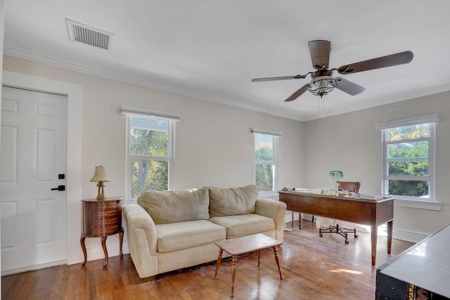 living room with hardwood / wood-style flooring, ceiling fan, plenty of natural light, and crown molding