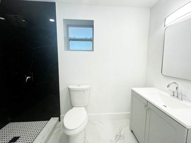 bathroom with baseboards, toilet, marble finish floor, vanity, and a walk in shower