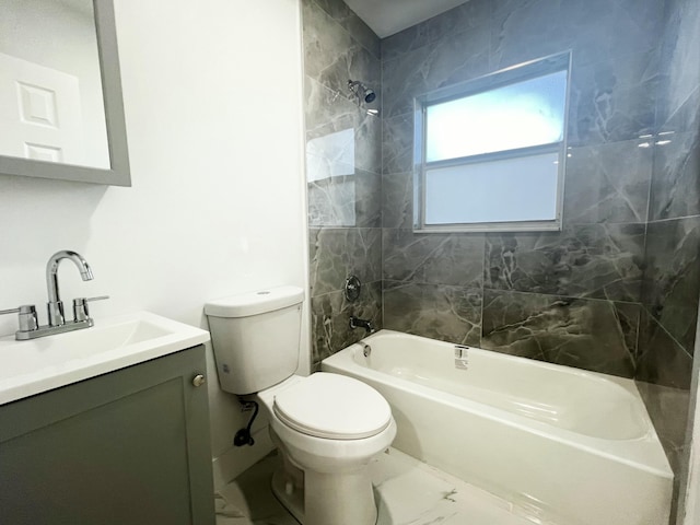 bathroom featuring toilet, marble finish floor, tub / shower combination, and vanity