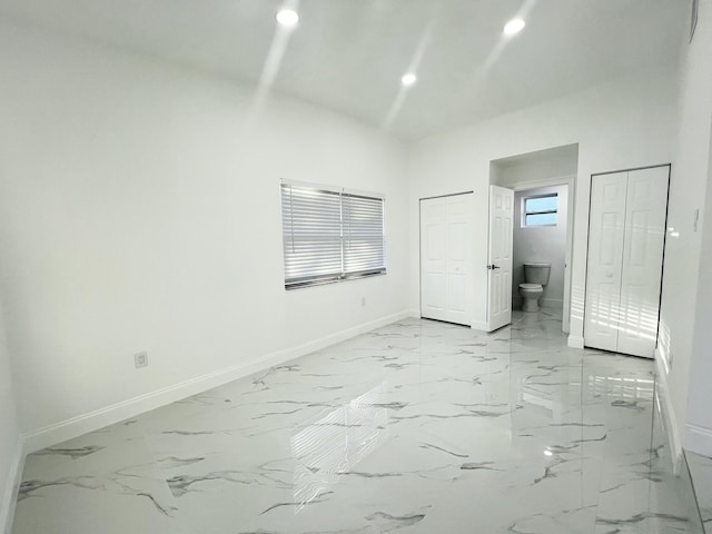 unfurnished bedroom featuring recessed lighting, marble finish floor, and baseboards