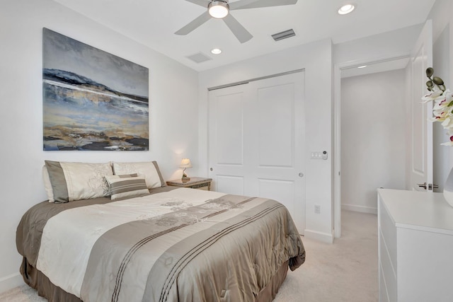 bedroom with light carpet, a closet, and ceiling fan