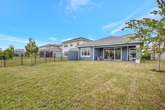 back of property featuring a yard and a patio