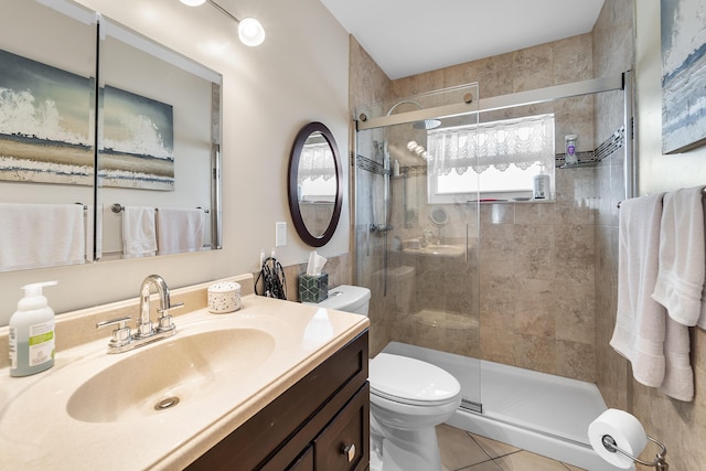 bathroom featuring an enclosed shower, vanity, tile patterned floors, and toilet