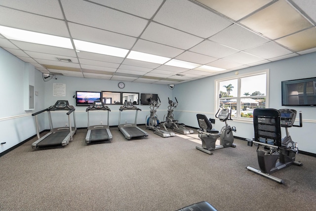 workout area with a drop ceiling and electric panel