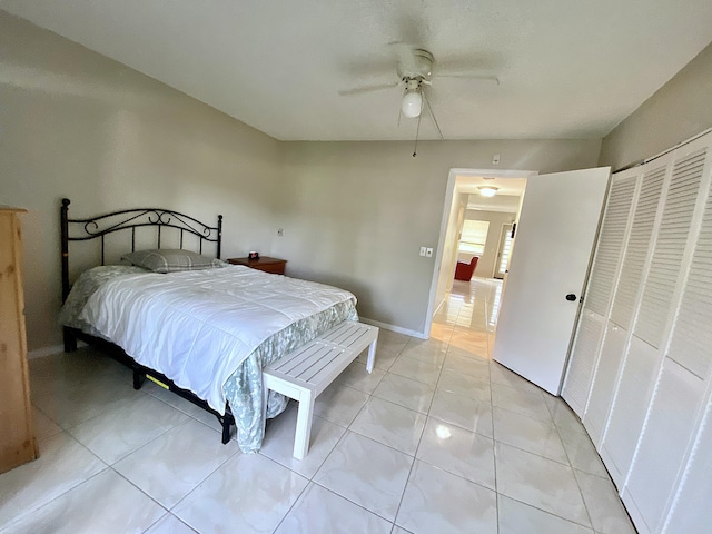 tiled bedroom featuring a closet and ceiling fan