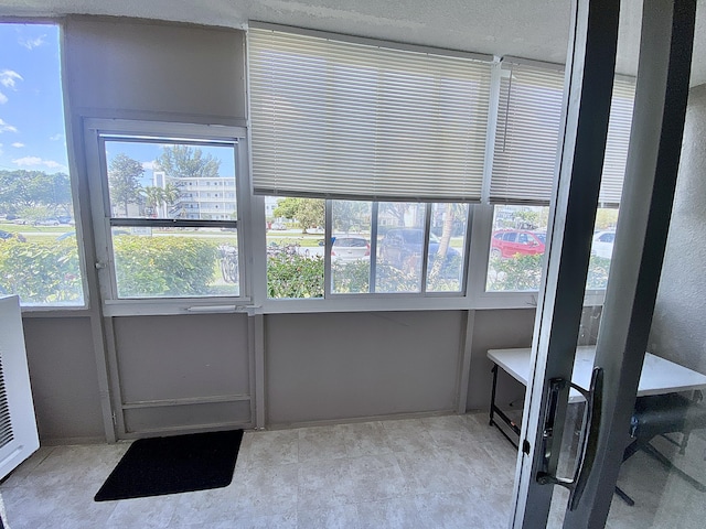 unfurnished sunroom featuring a healthy amount of sunlight