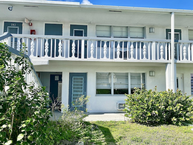 view of exterior entry with a balcony