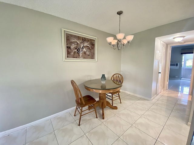 tiled dining space with a textured ceiling and a notable chandelier