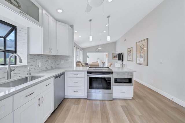 kitchen with sink, backsplash, stainless steel appliances, white cabinets, and kitchen peninsula