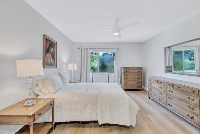 bedroom with ceiling fan and light wood-type flooring