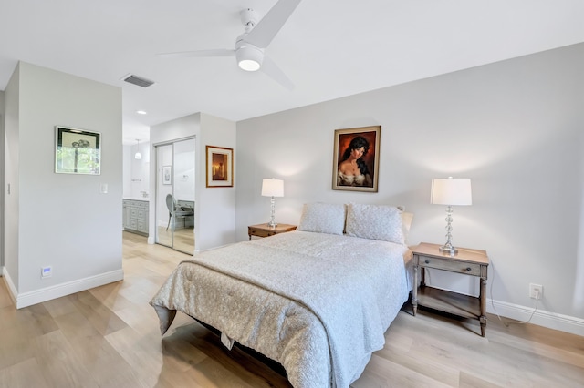 bedroom with ceiling fan, connected bathroom, light hardwood / wood-style floors, and a closet