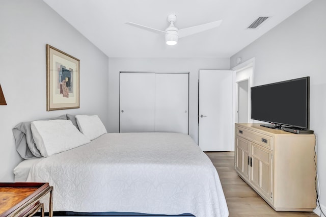 bedroom featuring a closet, ceiling fan, and light hardwood / wood-style flooring