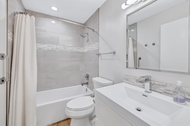 full bathroom featuring shower / tub combo, vanity, and toilet